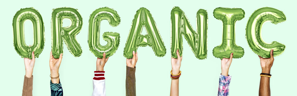 Hands showing organic balloons word Participatory Guarantee System, nghĩa là Hệ thống Bảo đảm Có sự Tham gia.